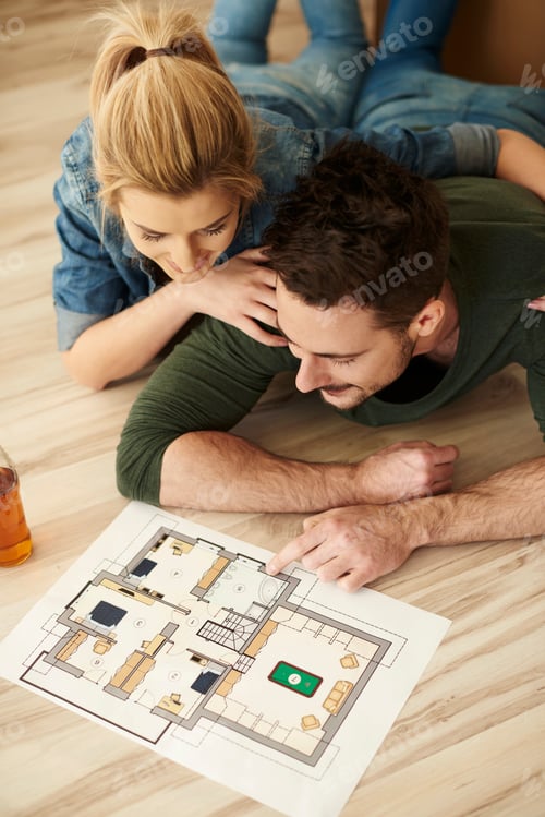 Preview: Couple looking at paint swatches and floorplan