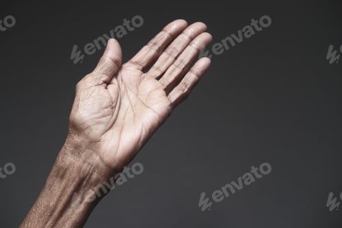 Preview: close up of hands of a elderly person against gray background