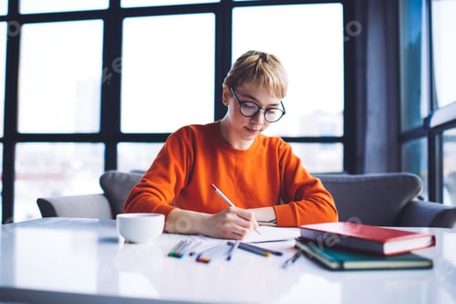 Preview: Focused woman writing notes on paper