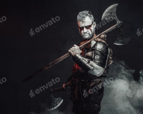 Preview: Serious and violent warrior from fantasy with two axes in studio