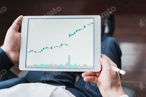 Preview: Businessman, investor,trader analyzing,looking at chart of stock prices in tablet. CEO,general manag