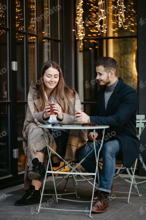Preview: Happy couple in outdoor cafe on autumn day