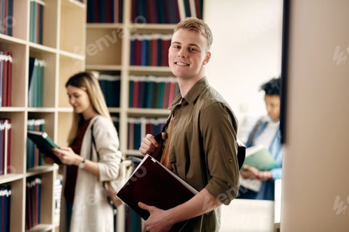 Preview: Portrait of happy male student in a library at the university.