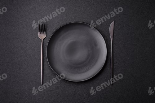 Preview: Cutlery fork, knife and spoon on a dark textured concrete background