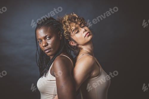 Preview: Two girls from different ethnicities posing in studio for a "body positivity" photo session