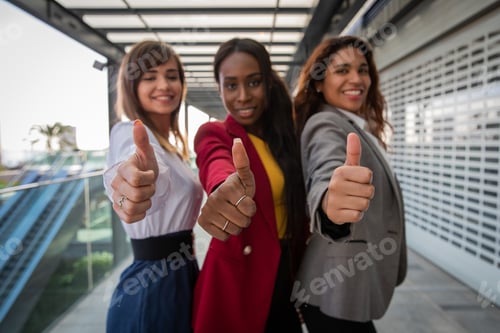 Preview: Three businesswomen with thumbs up, expression of satisfaction and approval.
