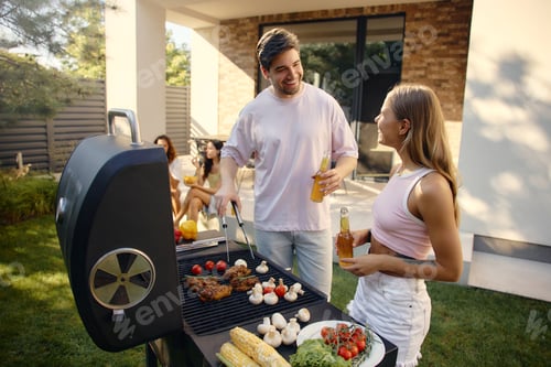 Preview: Friends enjoying summer barbecue party in backyard