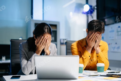 Preview: A stressed business team working late at night, facing deadlines and financial issues in the office.
