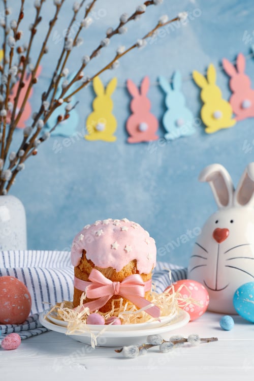 Preview: Easter composition with Easter cake and eggs on white wooden table against blue background