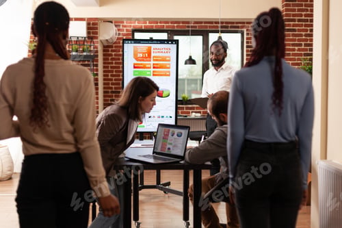 Preview: Business team sitting at meeting table in startup company office