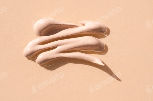 Preview: Texture smear of cosmetic cream, on beige background.