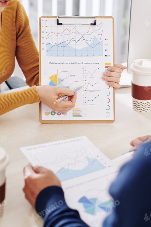 Preview: Business people discussing financial data