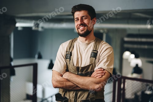 Preview: Smiling man in work attire stands confidently in a modern workspace during daylight hours