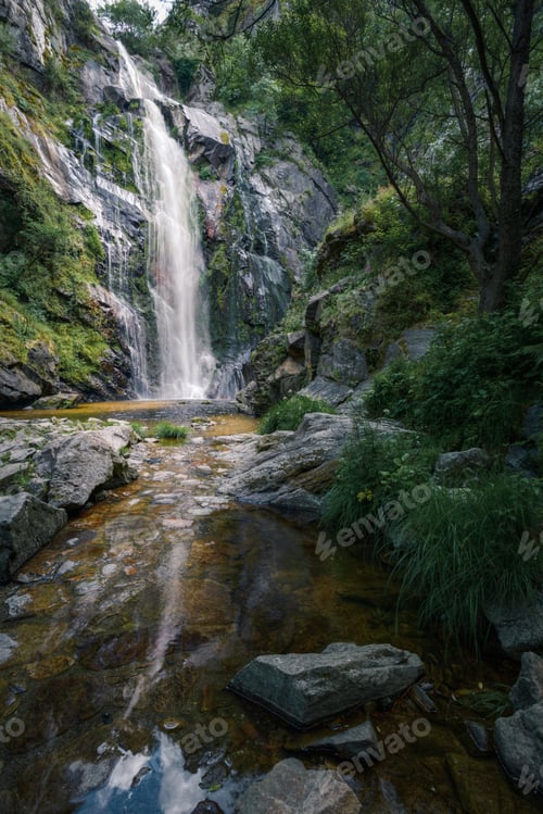 Preview: Waterfall caresses the granite rock before falling into a pool and forming a stream