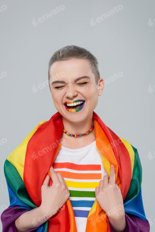 Preview: happy woman with lgbt flag and lips in rainbow colors laughing isolated on grey