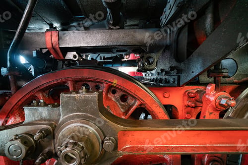 Preview: Closeup shot of a red valve gear of an old locomotive with greasy and rusty steam engine