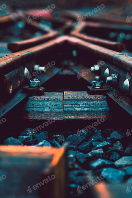 Preview: Vertical shot of railway trucks and pebbles outdoors