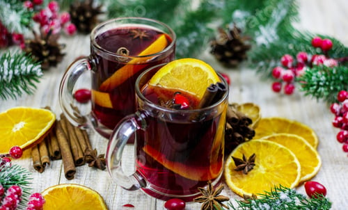 Preview: cups with hot mulled wine on a wooden background.