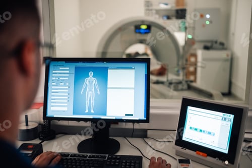 Preview: Technician monitoring patient data during CT scan process