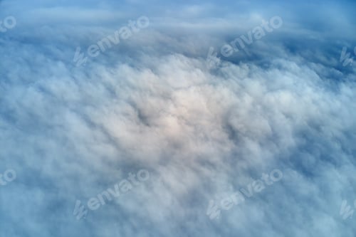 Preview: Aerial view from high altitude of earth covered with puffy rainy clouds forming before rainstorm