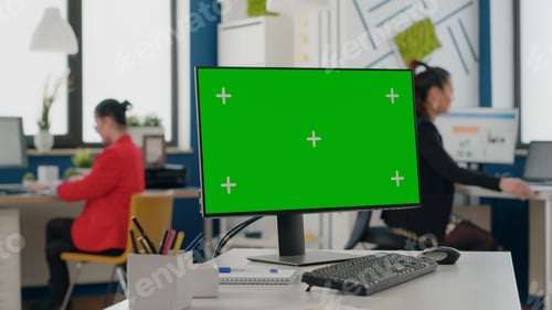 Preview: Close up of computer with isolated green screen at empty desk