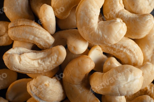 Preview: Cashew nuts macro photography, close-up of a heap of nuts, top view. Healthy food, selective focus