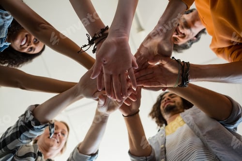 Preview: Low angle view of friends stacking hands