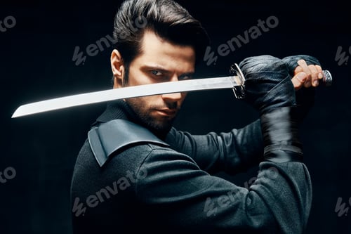 Preview: Warrior man posing with a sword ready to stab enemy