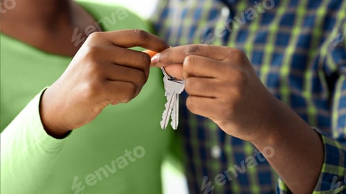 Preview: New Home Concept. Closeup Shot Of Happy Black Couple Holding Keys Together