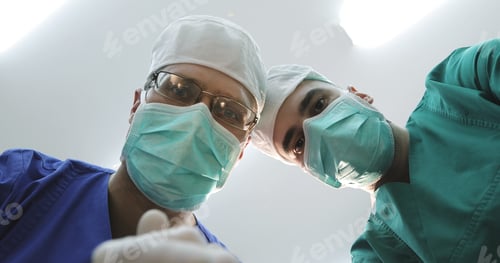 Preview: Close-Up. Doctors In Masks And Medical Uniforms Looks Down At Patient. Surgeons Shake Their Heads