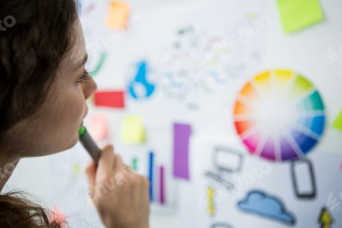 Preview: Thoughtful woman looking at adhesive notes