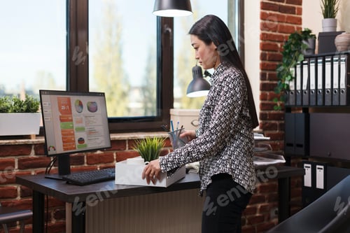Preview: Unhappy asian office worker gathering personal objects after being fired by general manager