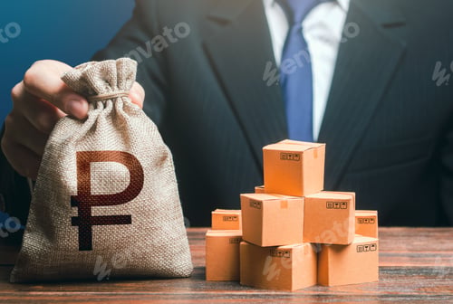 Preview: Businessman holds russian ruble money bag and boxes with goods.