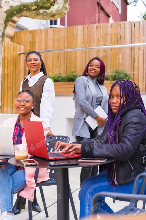 Preview: Young businesswomen of black ethnicity. In a business meeting in a cafeteria