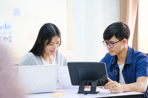 Preview: Two People Discussing Business at a Table