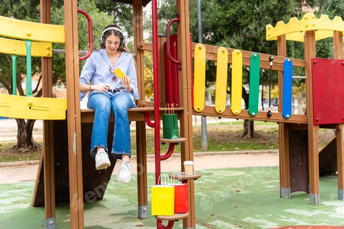 Preview: College girl shopping, taking a break at playground