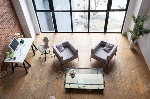Preview: A bright room with a modern minimalist design. There is a sofa and flowers against the wall