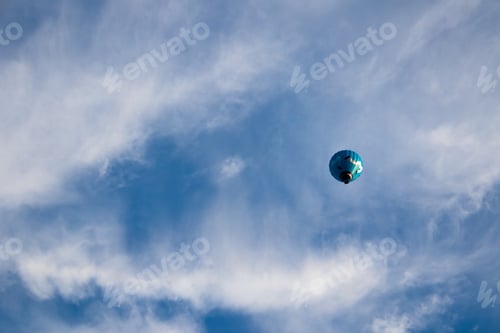 Preview: Beautiful view of a floating hot air balloon with a cloudy sky background