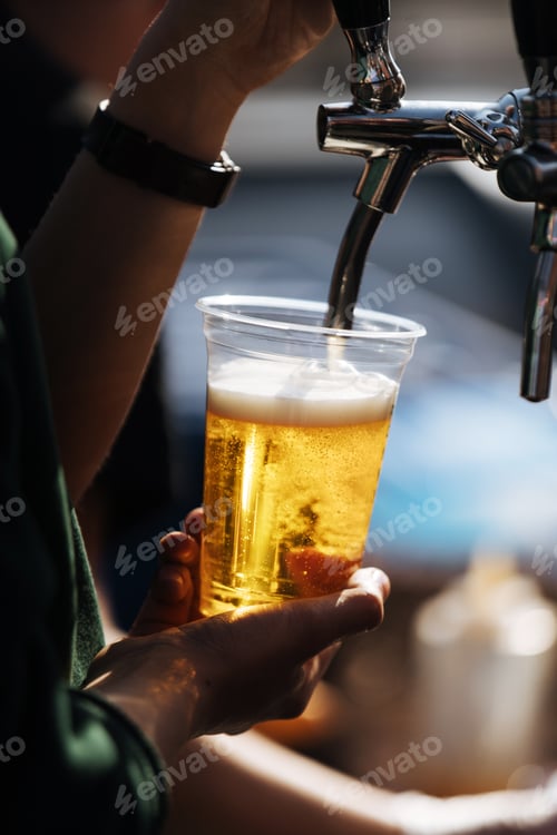 Preview: Crop person pouring beer on tap