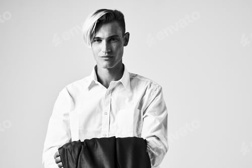 Preview: handsome man with a jacket in his hands fashion confidence for you Studio posing
