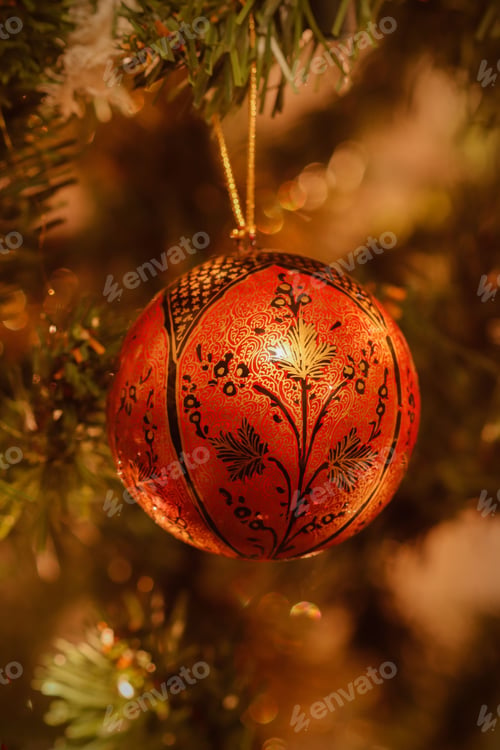 Preview: Vertical close-up of festive holiday decorations hanging from a Christmas tree