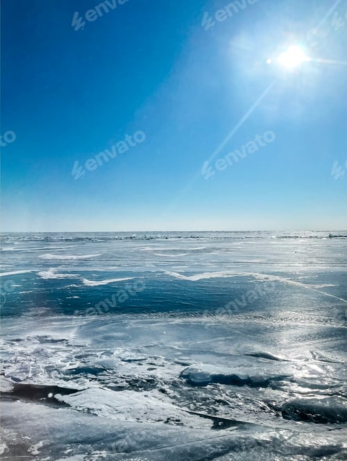 Preview: Texture of beautiful blue ice with cracks and air bubbles in the frozen lake.