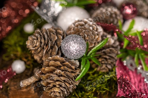 Preview: Closeup shot of pinecones and sparkly ornaments on a Christmas tree