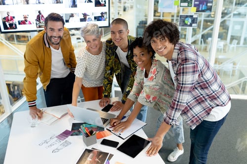 Preview: Portrait of diverse business people discussing over laptop in the conference room at office