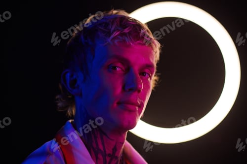 Preview: Young Man Standing in Neon Light