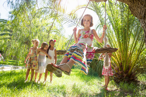 Preview: Girls queueing for tree swing in garden
