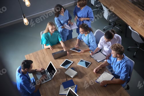 Preview: Group of medical students with gadgets in college, top view
