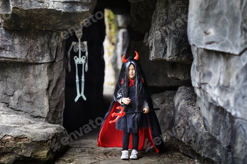 Preview: Cute little Caucasian girl wearing Halloween costume outdoor