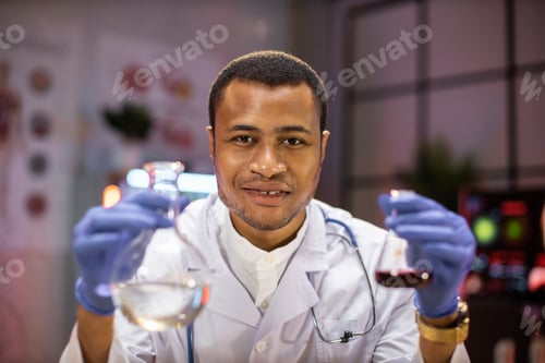 Preview: Yong african male scientist working with test tubes wearing lab coat working in laboratory