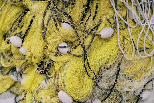 Preview: Folded yellow fishing net with white floats. Top view